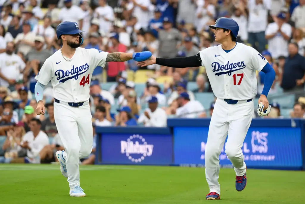 Dodgers’ Shohei Ohtani, right, celebrates with Andy Pages after scoring...
