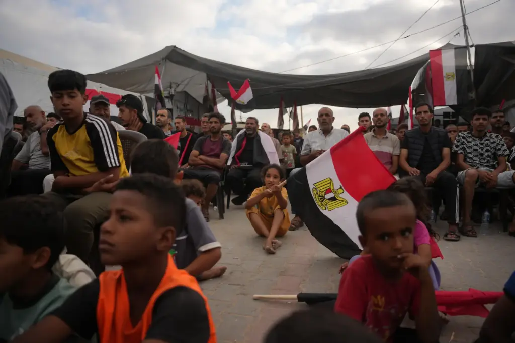 Palestinians watch a live broadcast of the World Cup soccer match between Egypt and Iran.