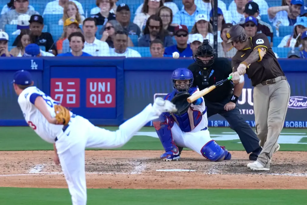San Diego Padres’ Manny Machado, right, hits a three-run home...