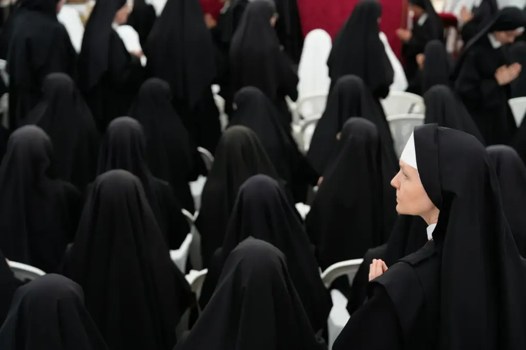 Nuns attend a consecration ceremony for four new bishops.
