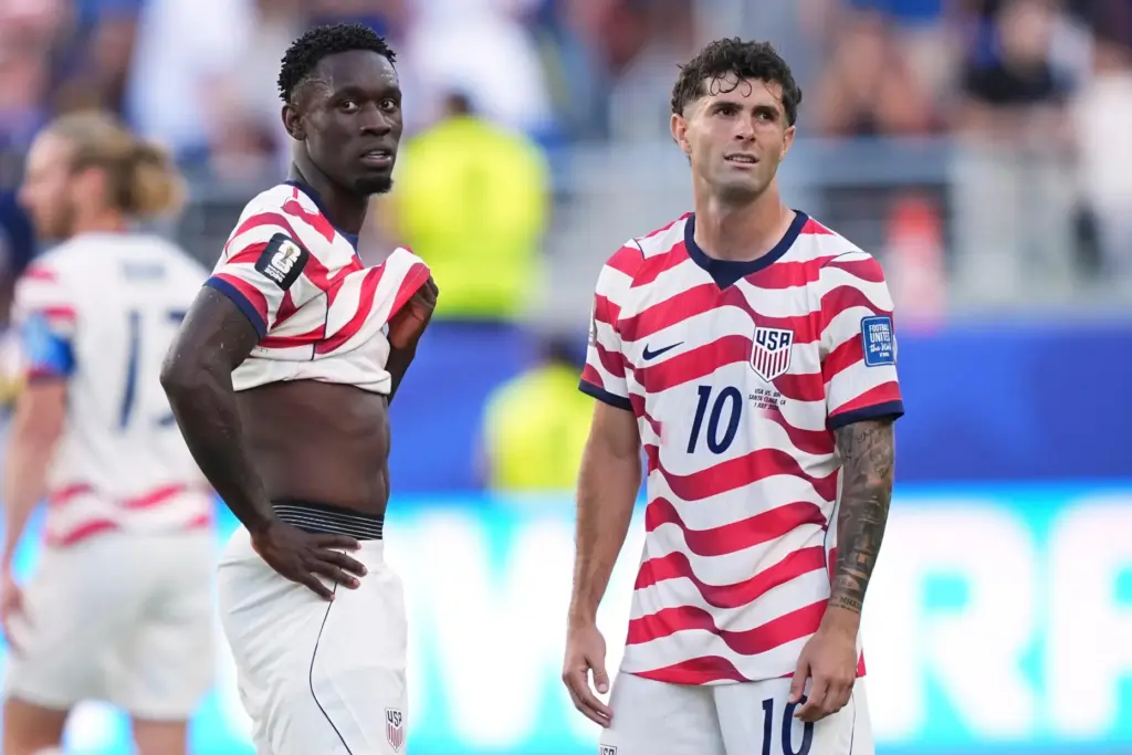 Folarin Balogun and Christian Pulisic stand by after Balogun received a red card.