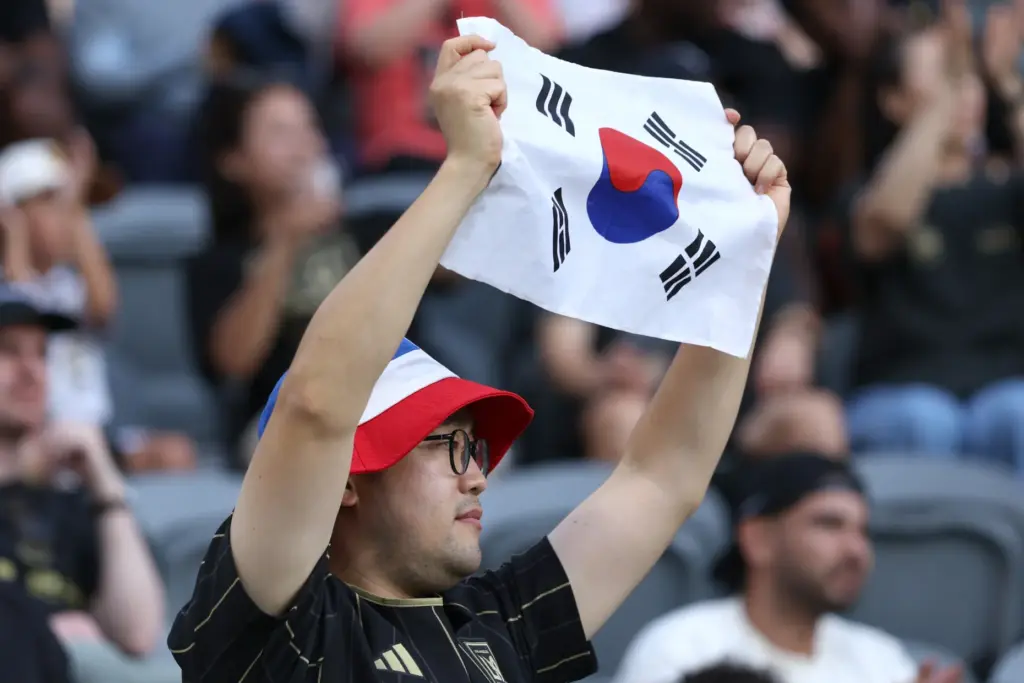 A fan holds up a South Korea flag before the...