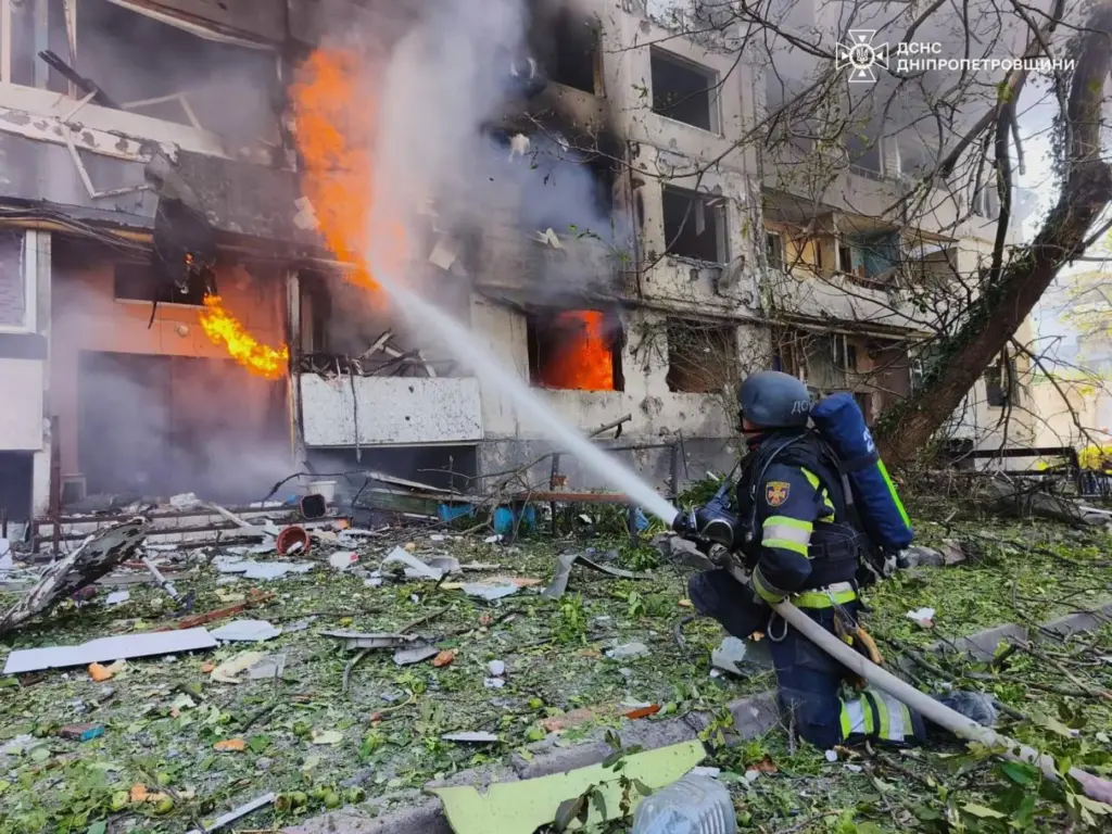 Firefighters put out a fire in a residential building following a Russian air attack.