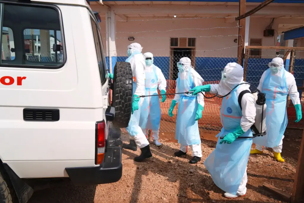Health workers disinfects an ambulance at Ebola Treatment Center at...