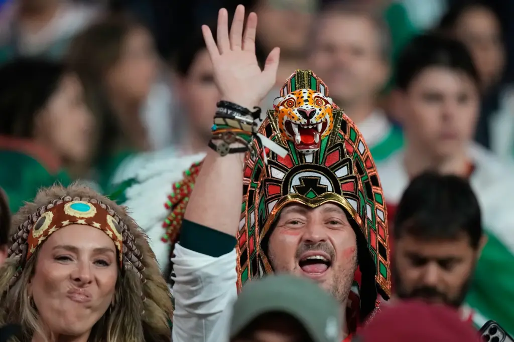 Fans react before the World Cup round of 32 soccer...