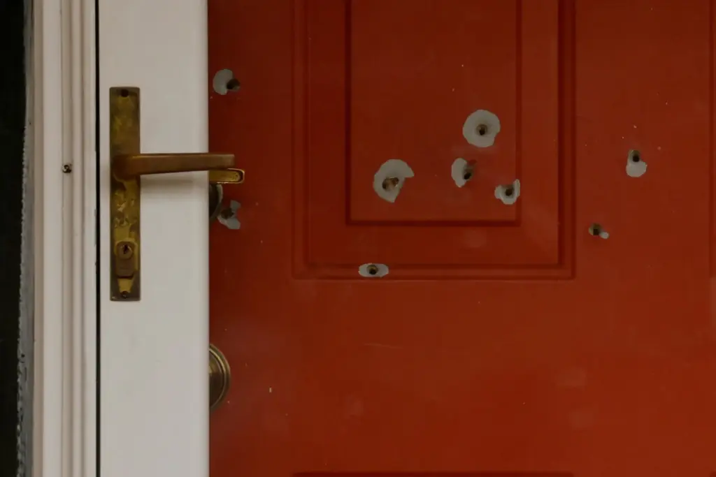 Bullet holes mark the front door of the house of Minnesota state Sen. John Hoffman.