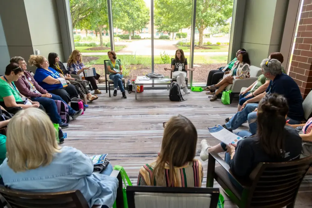 Attendees meet in a group setting to talk about widowhood...