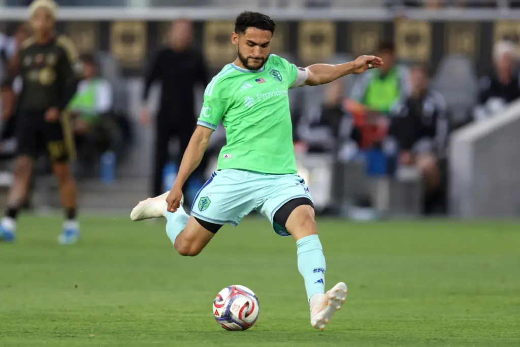 Seattle Sounders FC midfielder Cristian Roldan kicks the ball against...