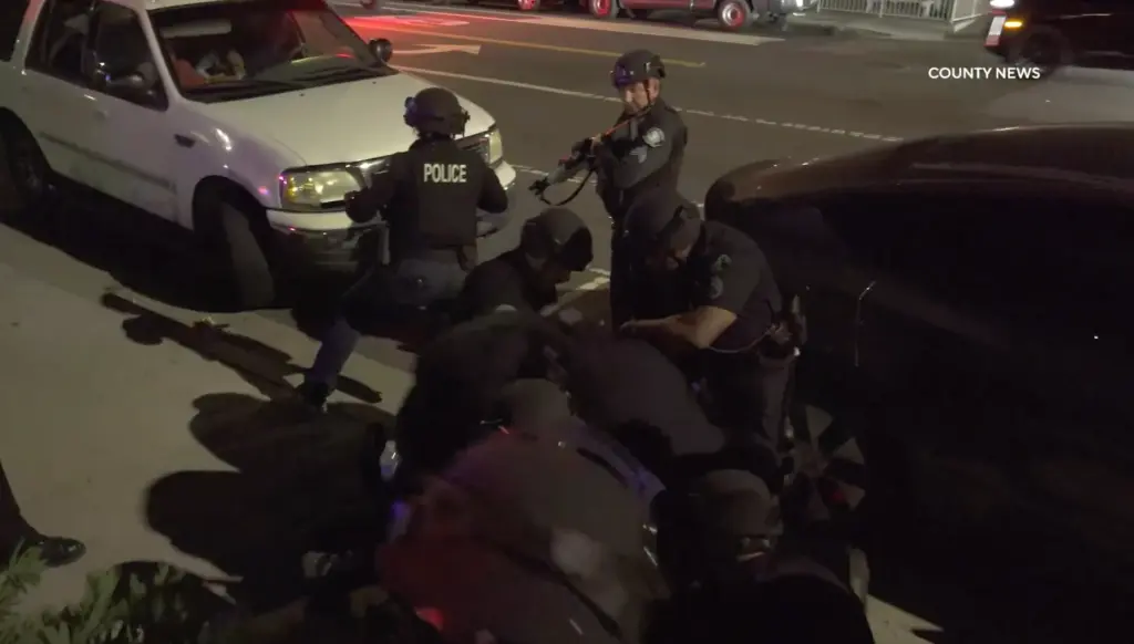 Police take a person into custody on Saturday, July 4th,...