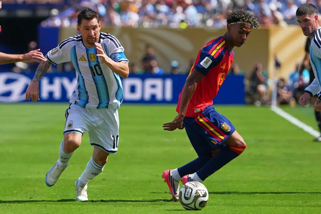 Argentina’s Lionel Messi (10) vies for the ball with Spain’s...