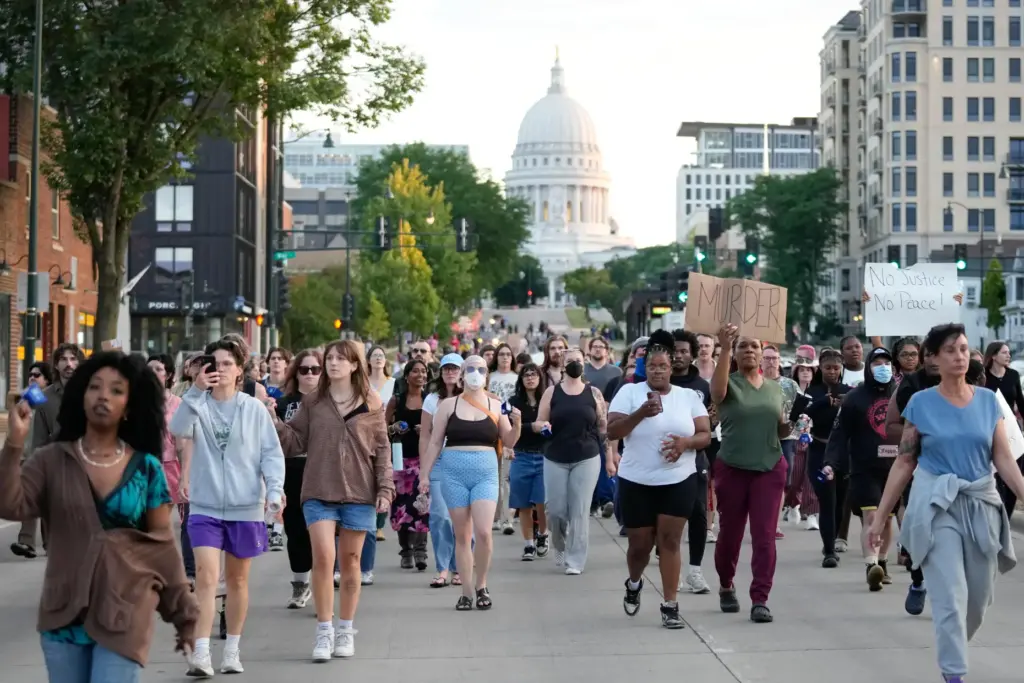 Protesters march after a Madison police officer shot and killed...