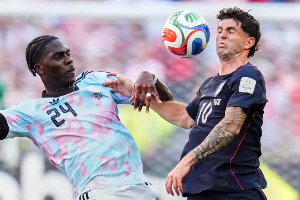 Belgium’s Amadou Onana, left, and United States’ Christian Pulisic battle...