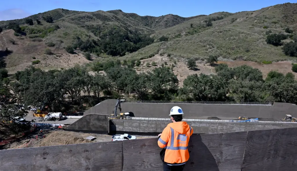 Diego Banda, Caltrans resident engineer, right, views the work on...