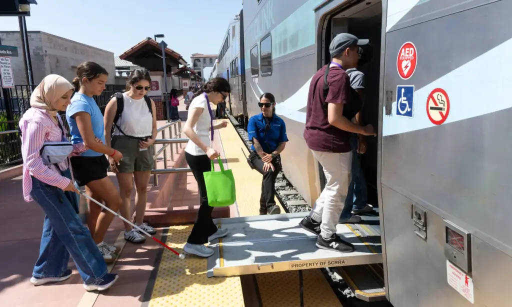 Campers board the Metrolink train at the Santa Ana Regional...