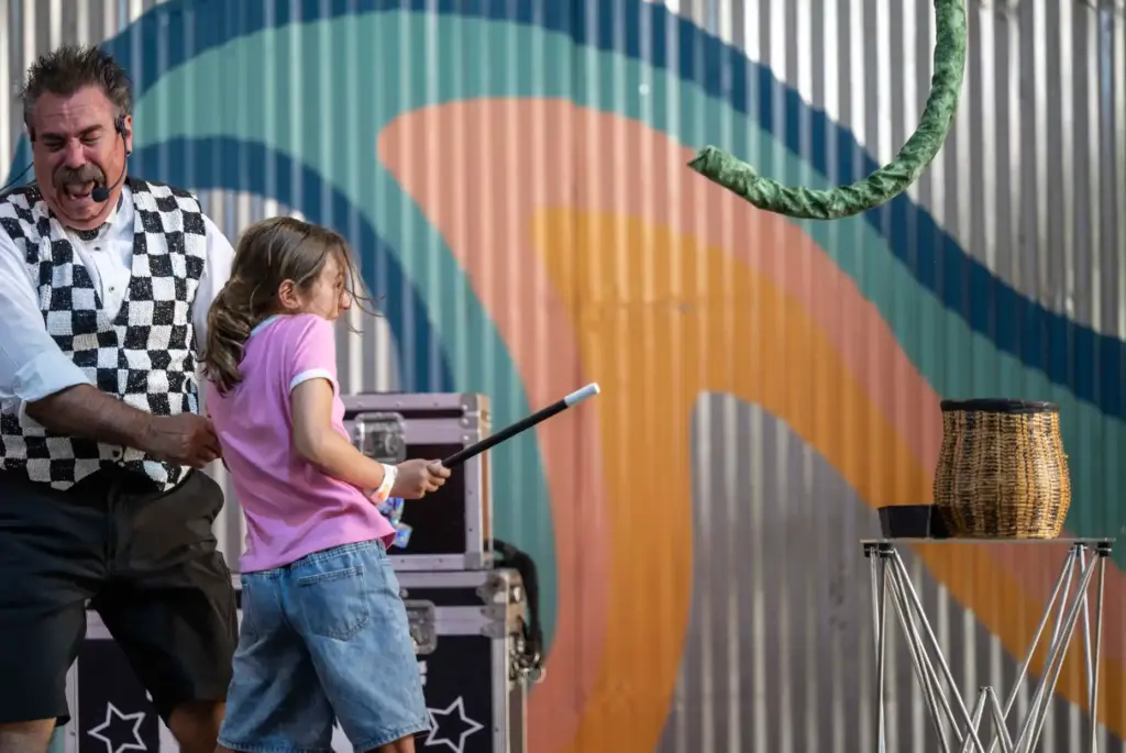 Audience volunteer Delilah Rose, 9, of Fullerton jumps back as...
