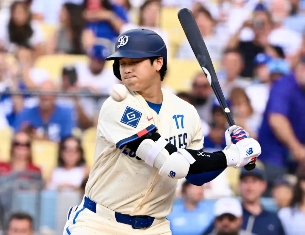 Shohei Ohtani of the Dodgers is brushed back by a...