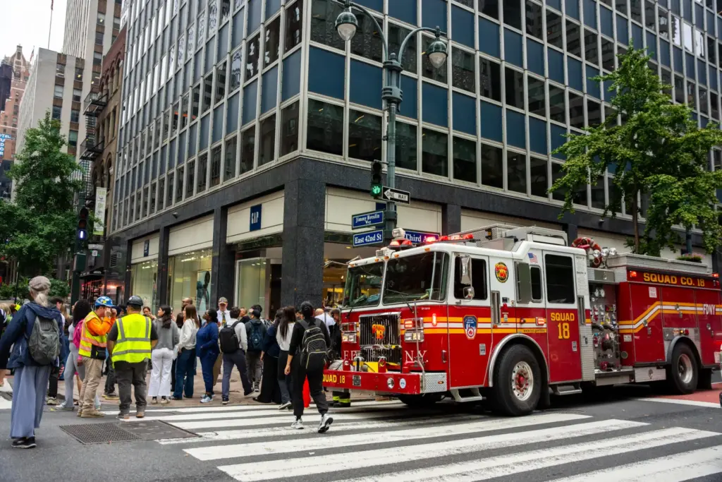 A firetruck is parked at the intersection of 3rd Avenue...