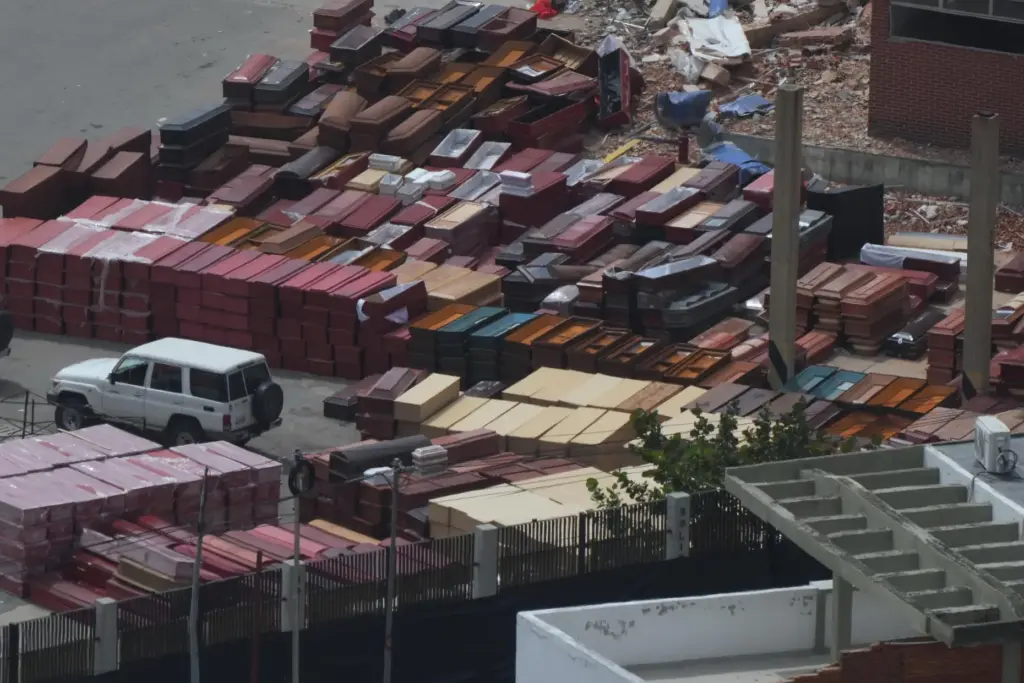 Coffins are stacked at the seaport where forensic workers sort...