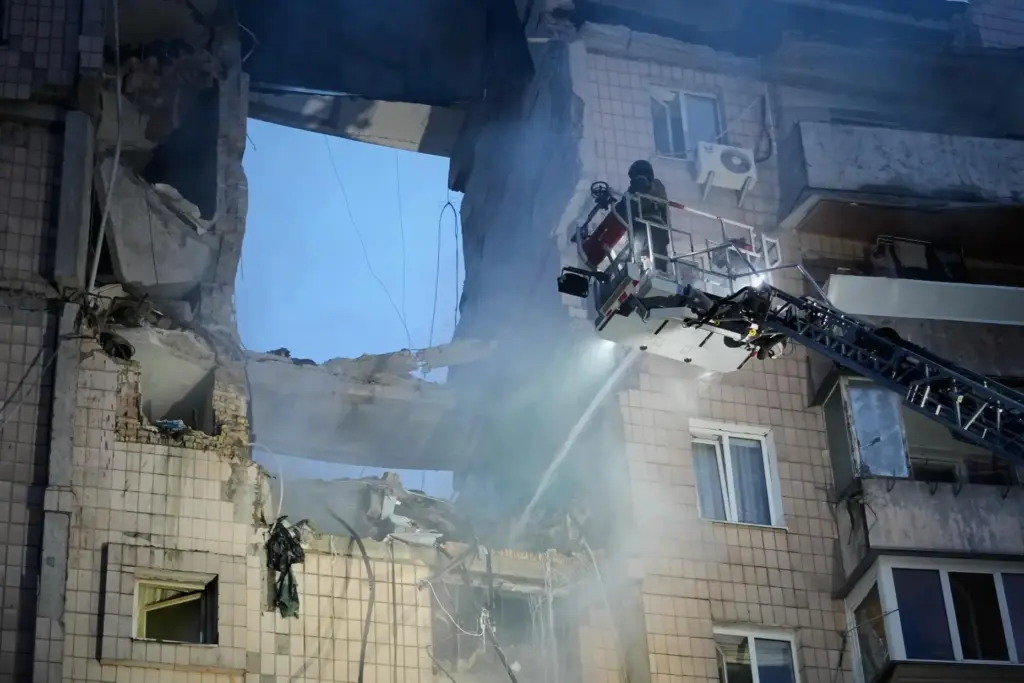 Rescuers work the scene of a building damaged by Russian missile attack in Kyiv, Ukraine.