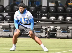 Chargers’ Tuli Tuipulotu works out on sideline while awaiting extension