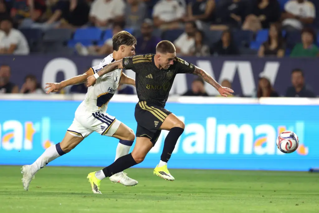 LAFC forward Tyler Boyd, right, pushes off on Galaxy defender...