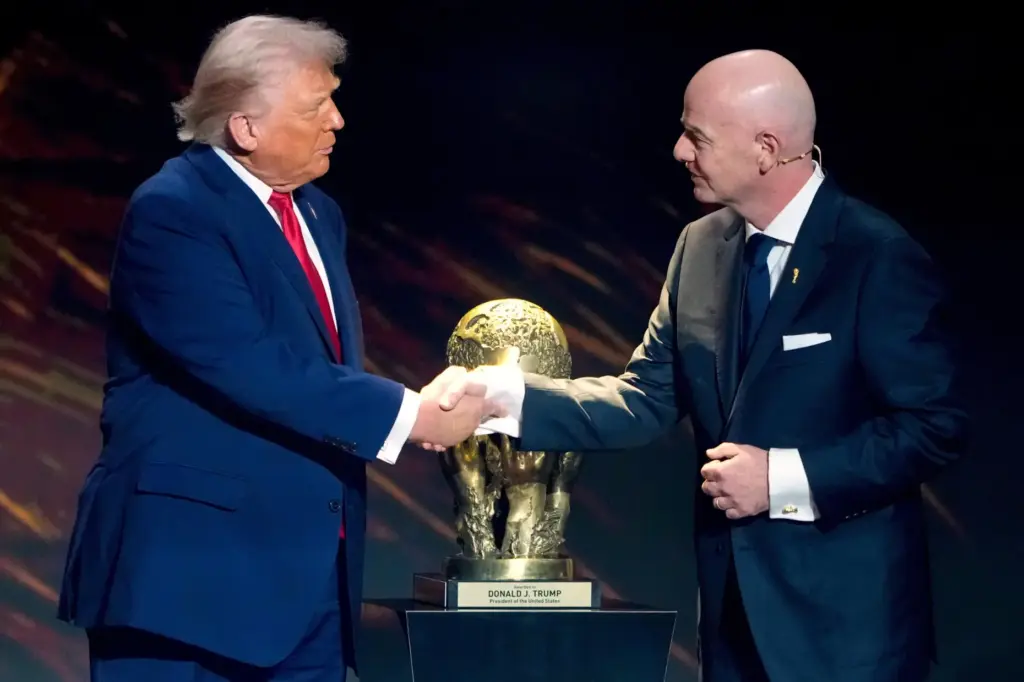 FILE – FIFA President Gianni Infantino, right, awards President Donald...
