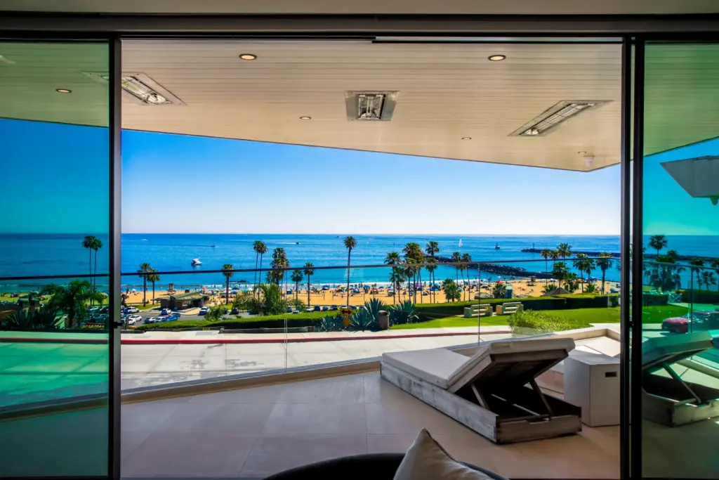The primary bedroom opens to a private balcony with ocean...