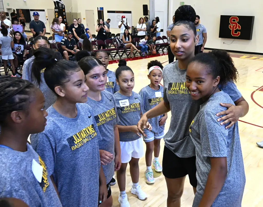 JuJu Watkins gets hugs from campers as she hosts a...