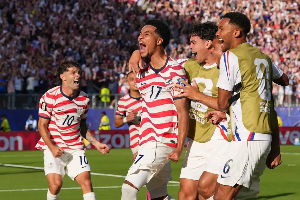 The United States’ Malik Tillman (17) celebrates with teammates after...