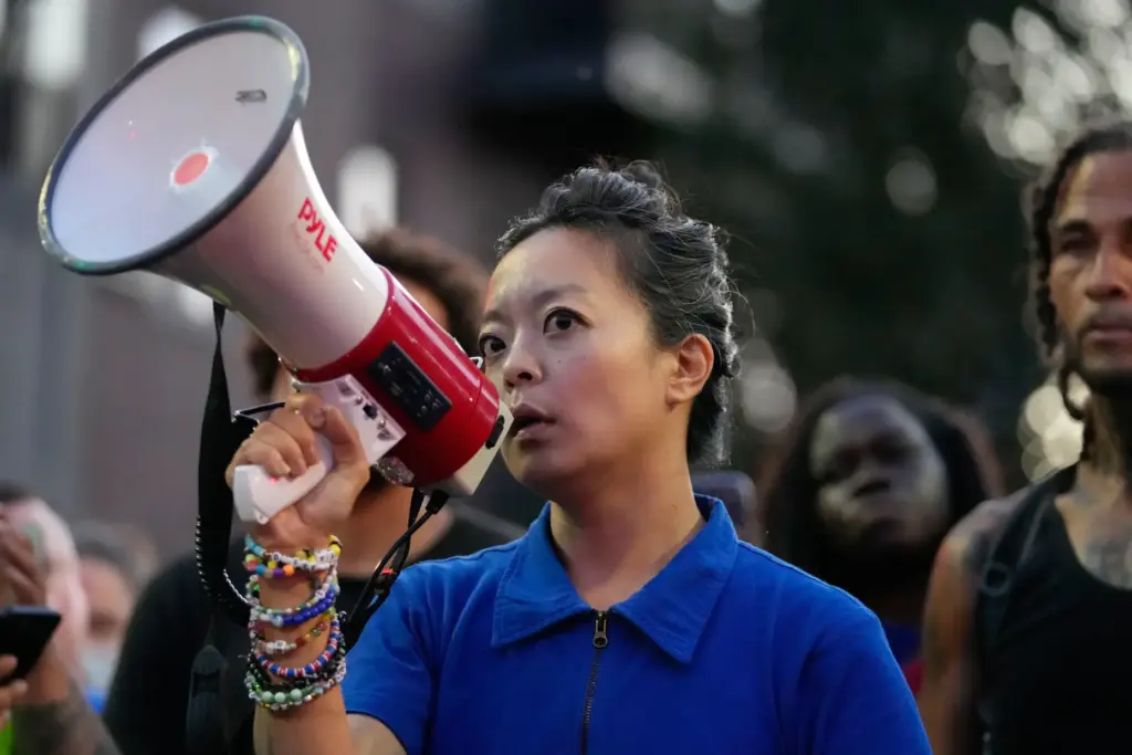 Gubernatorial candidate Francesca Hong speaks alongside protesters near where a...
