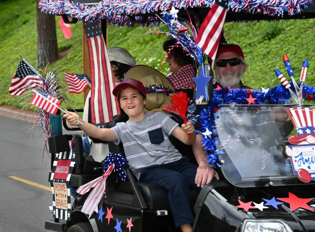 Waving a flag from a golf cart as they ride...
