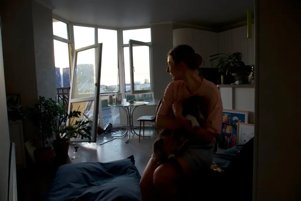 Julia Sosnovska hugs her dog Perry inside her apartment in...