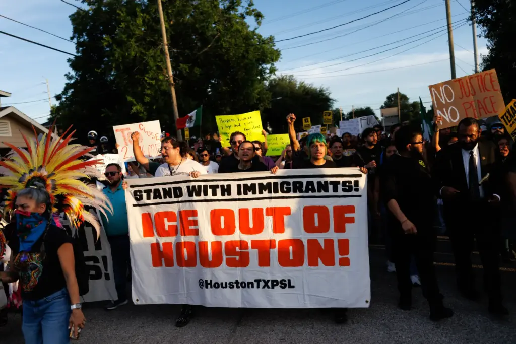 People march through the streets during a vigil for Lorenzo...