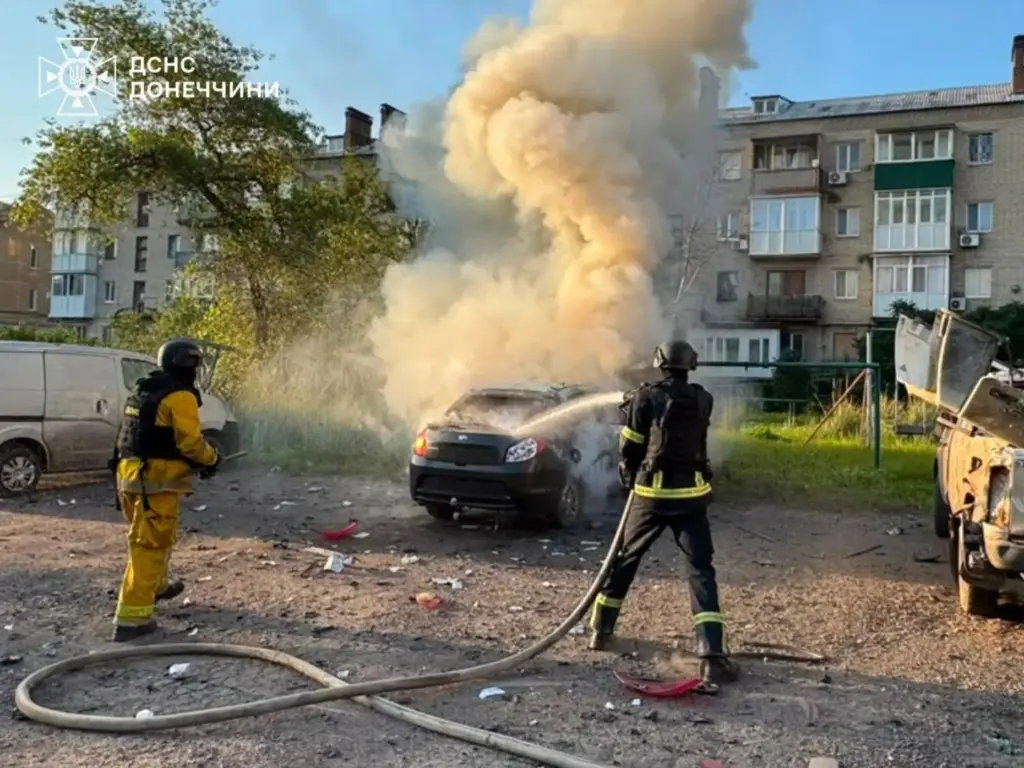 Emergency services personnel work to extinguish a fire following a Russian air attack.