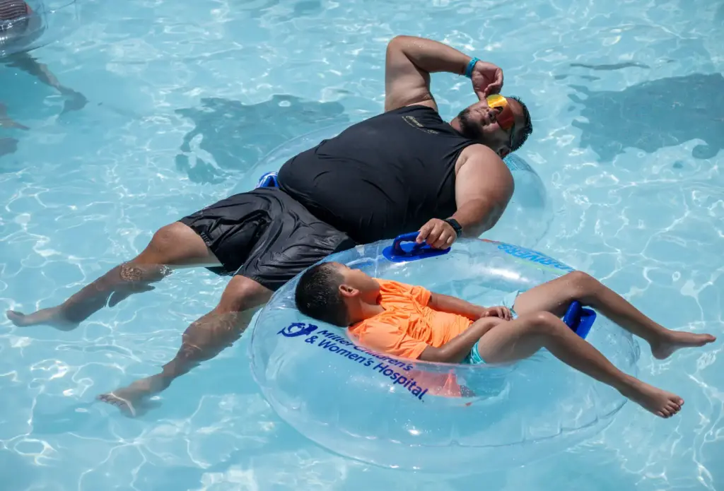 A dad and son cool off as they float down...