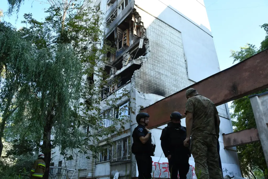 Rescuers work at the damaged apartment building following a Russian air attack in Lviv, Ukraine.