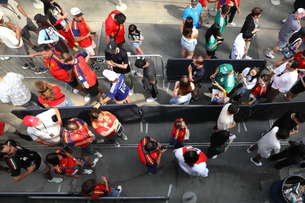 Soccer fans queue in line to enter the FIFA store...