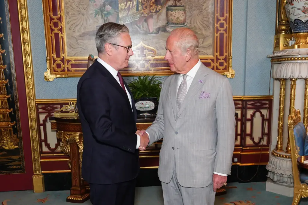 Britain's King Charles III welcomes outgoing Prime Minister Keir Starmer.