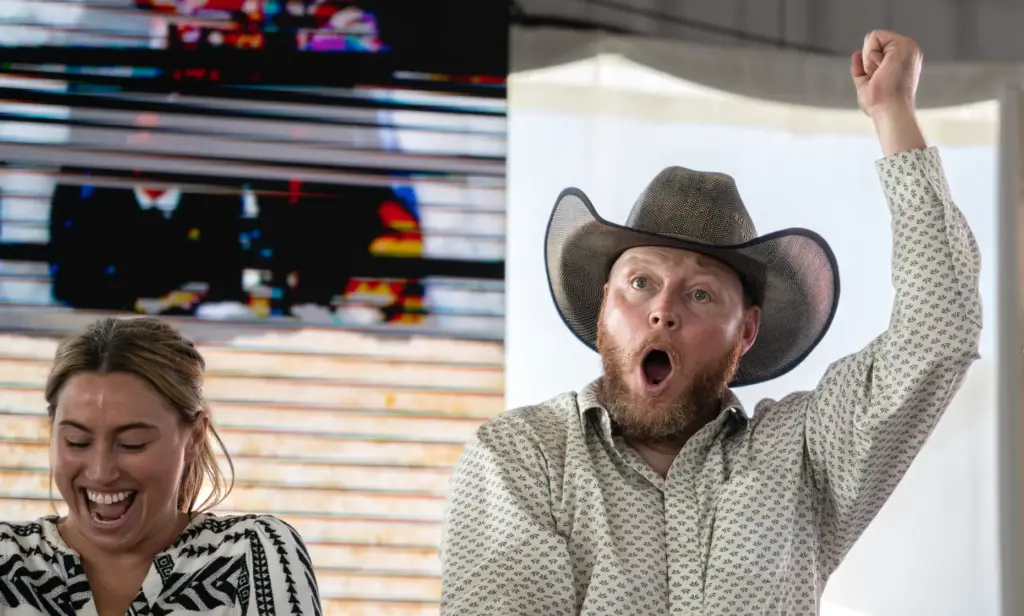 Auctioneer Jarett Bramley takes bids during the annual Junior Livestock...