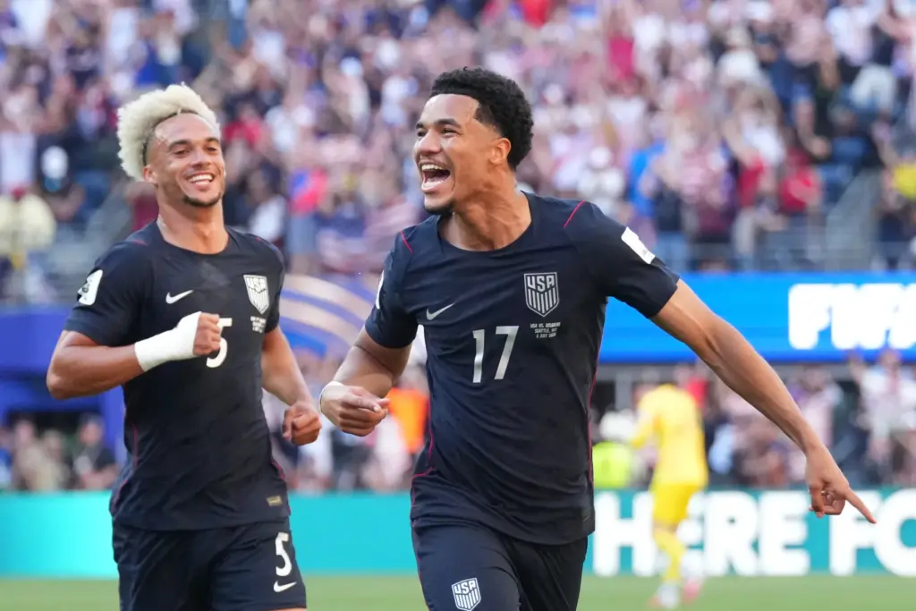 United States’ Malik Tillman (17) celebrates with United States’ Antonee...