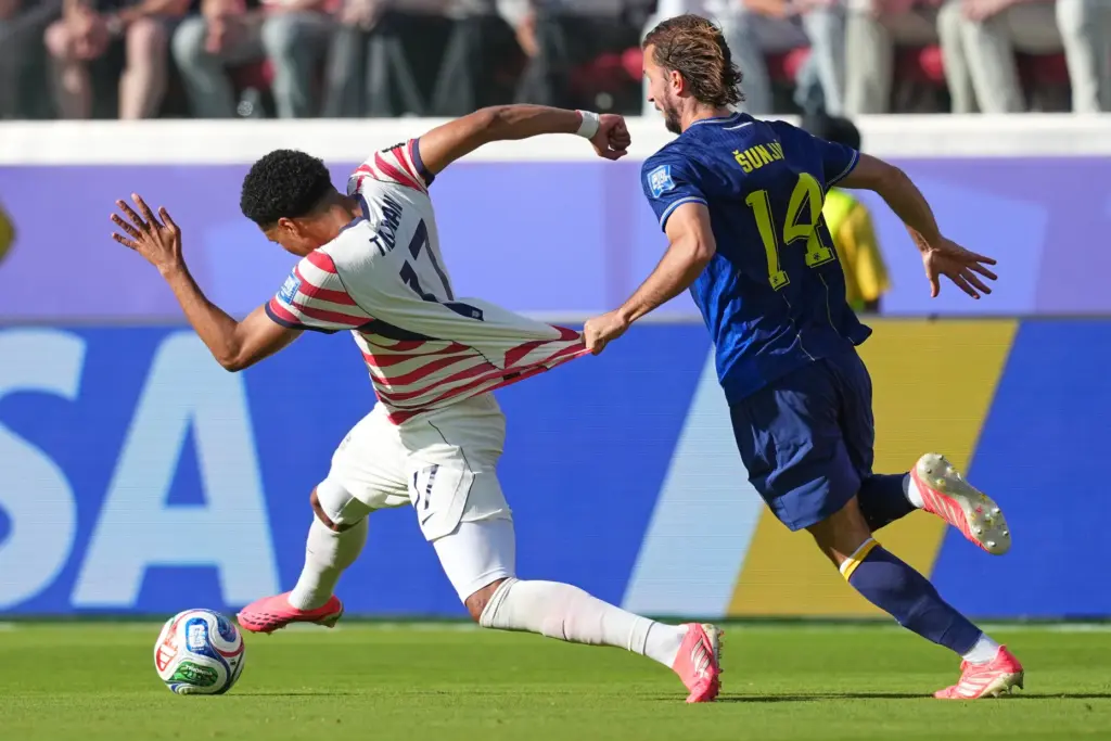 The United States’ Malik Tillman (17) and Bosnia’s Ivan Sunjic...
