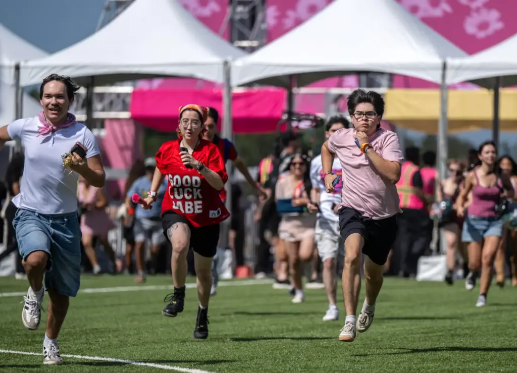 Festivalgoers sprint into the grounds as the gates open for...