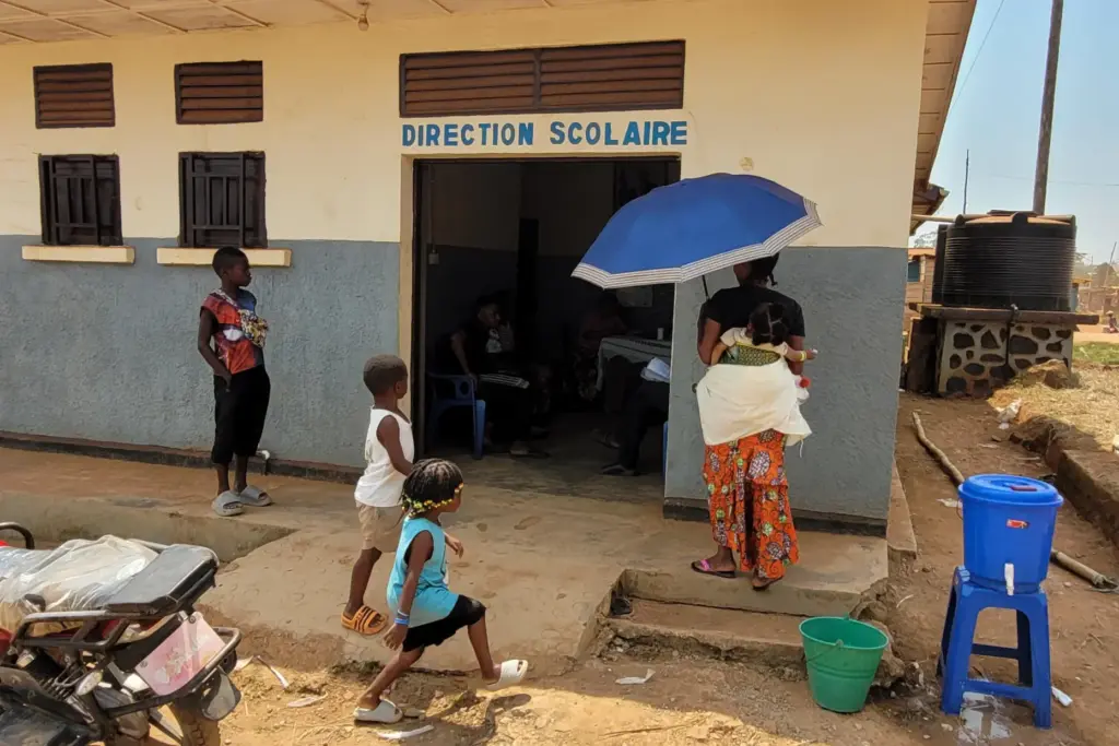 A parent who came for her child's school resumption stands outside the school.
