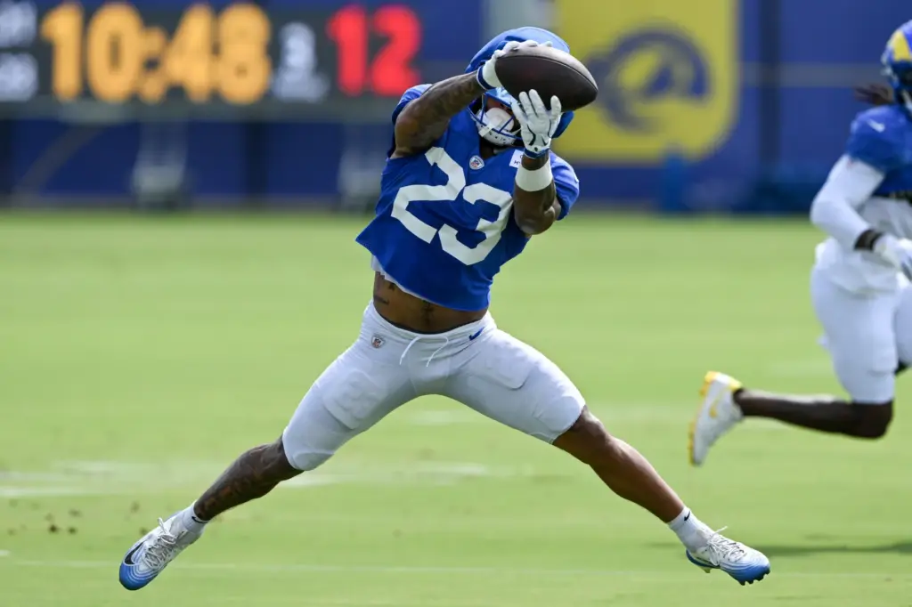 Rams running back Kyren Williams reaches to catch a pass...