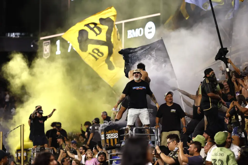 LAFC supporters cheer after their team scores a goal against...