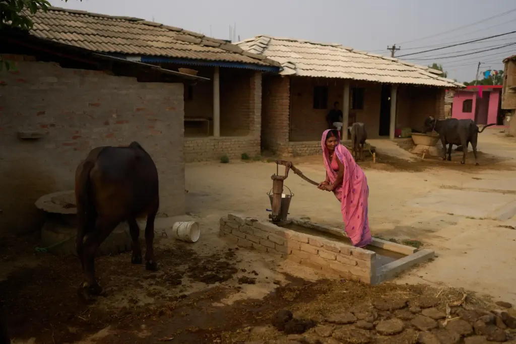 A woman collects water from a well in Gaur, Nepal.