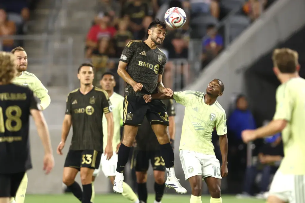 Los Angeles FC midfielder Mathieu ChoiniÃ¨re heads the ball defended...