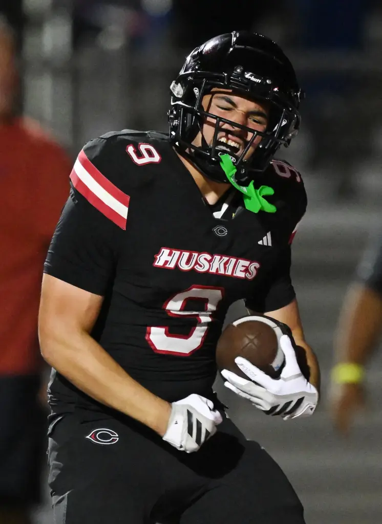 Centennial running back Braylin Drake (9) celebrates his touch down...