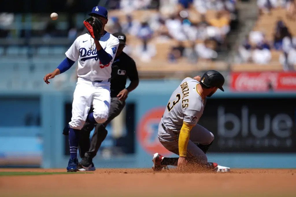 Pittsburgh Pirates’ Nick Gonzales, right, slides into second base during...
