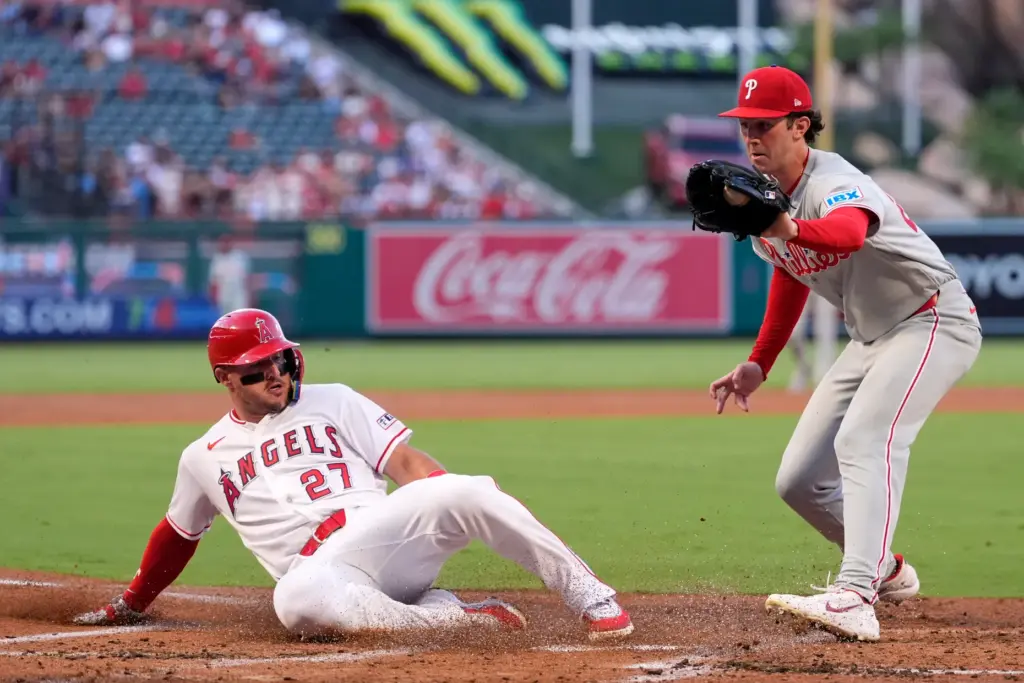 Angels star Mike Trout, left, scores on a wild pitch...